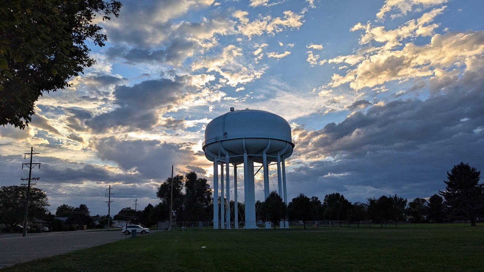 A neighborhood water tower closes the tour beneath a dramatic evening sky.