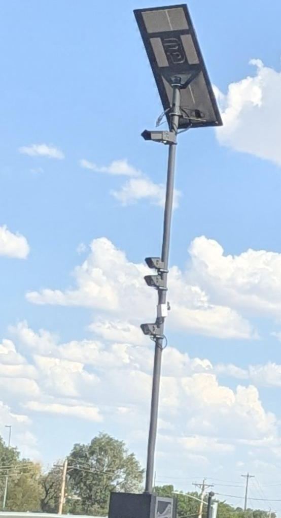 Camera tower with an equipment cabinet at its base
